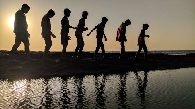 Group Of Children Walking Near Body Of Water Silhouette Photography